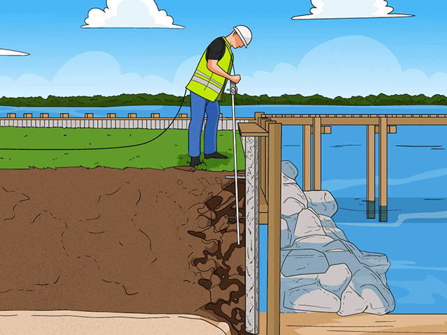 Worker in safety vest digging near a waterfront construction site.