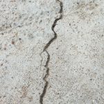 A jagged crack on a concrete surface.