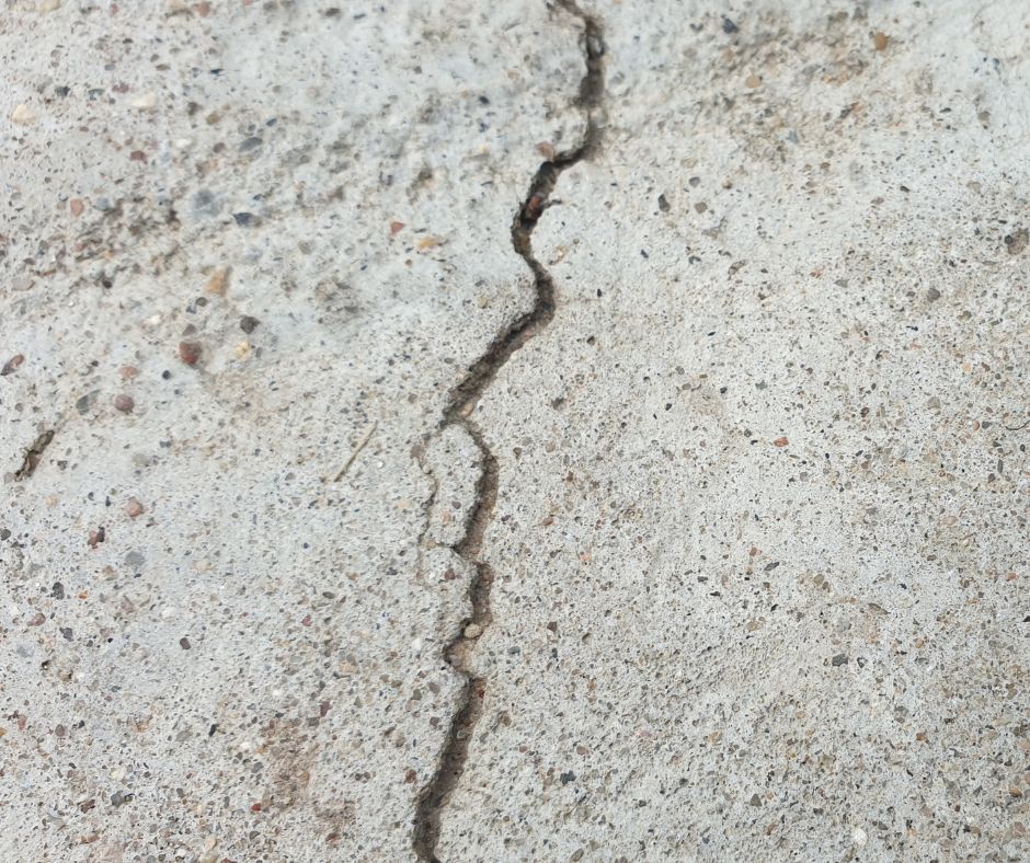 A jagged crack on a concrete surface.