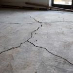 Cracked concrete floor with visible fissures.