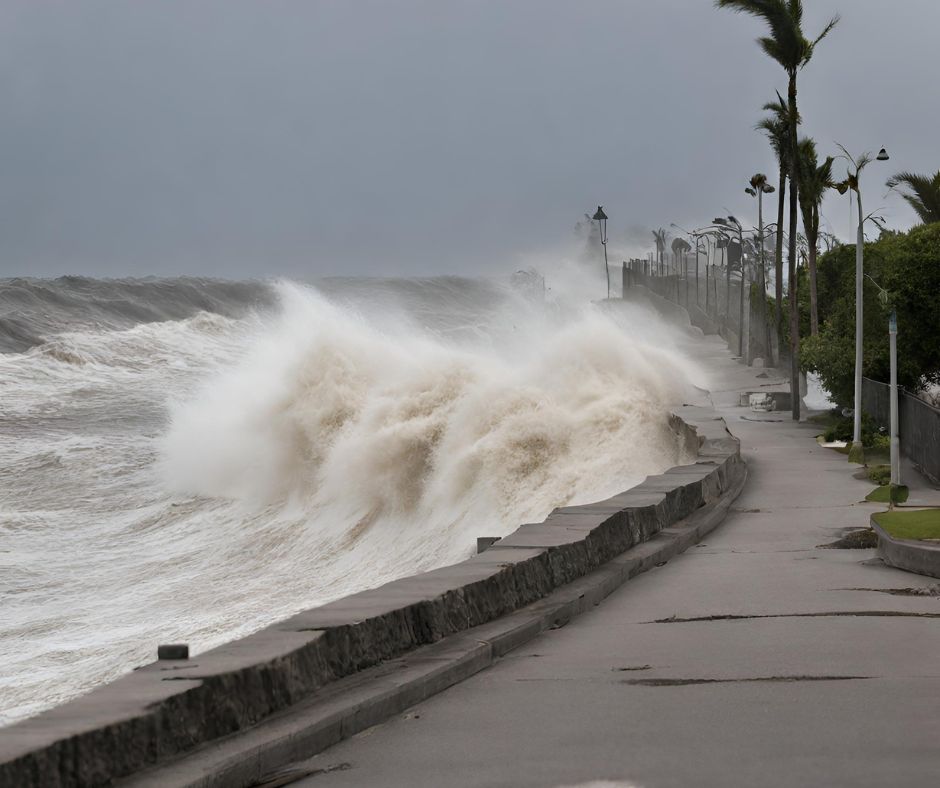 Powerful waves crash against a coastal seawall during a storm.