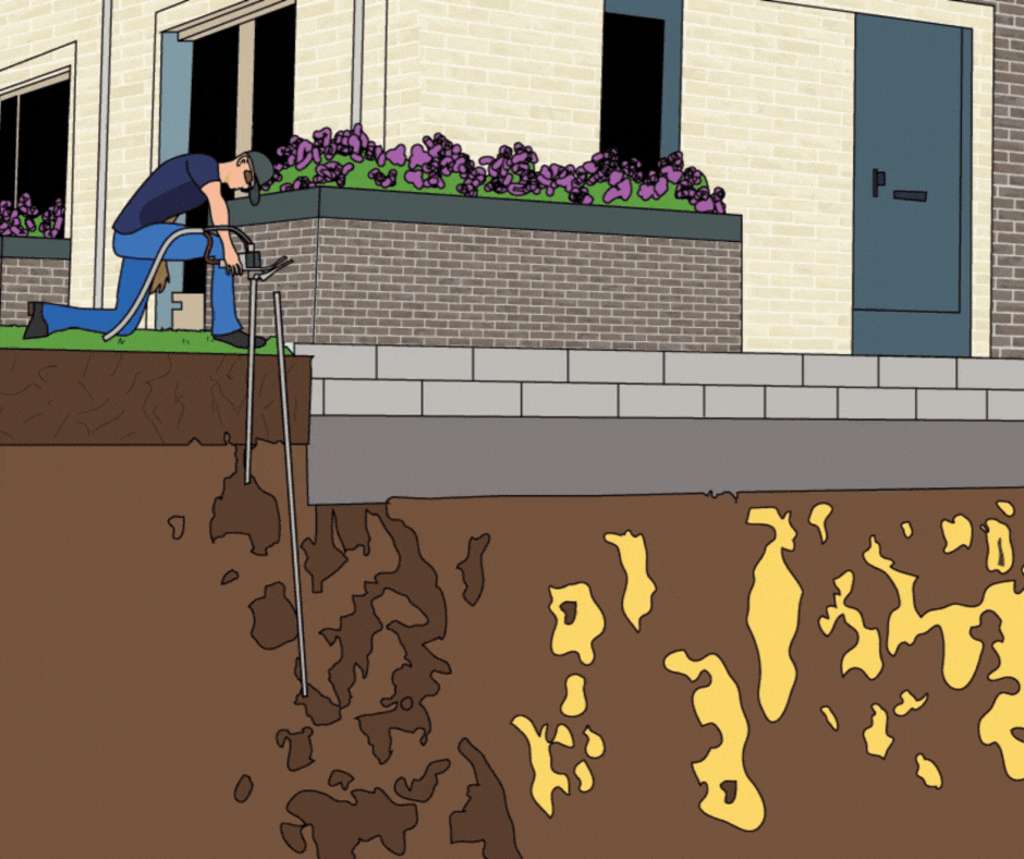 Person digging a trench near a building's foundation with visible underground soil layers.